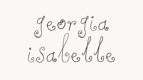 Hand-lettered text reading 'Georgia Isabelle' in dark gray script on a warm off-white background.